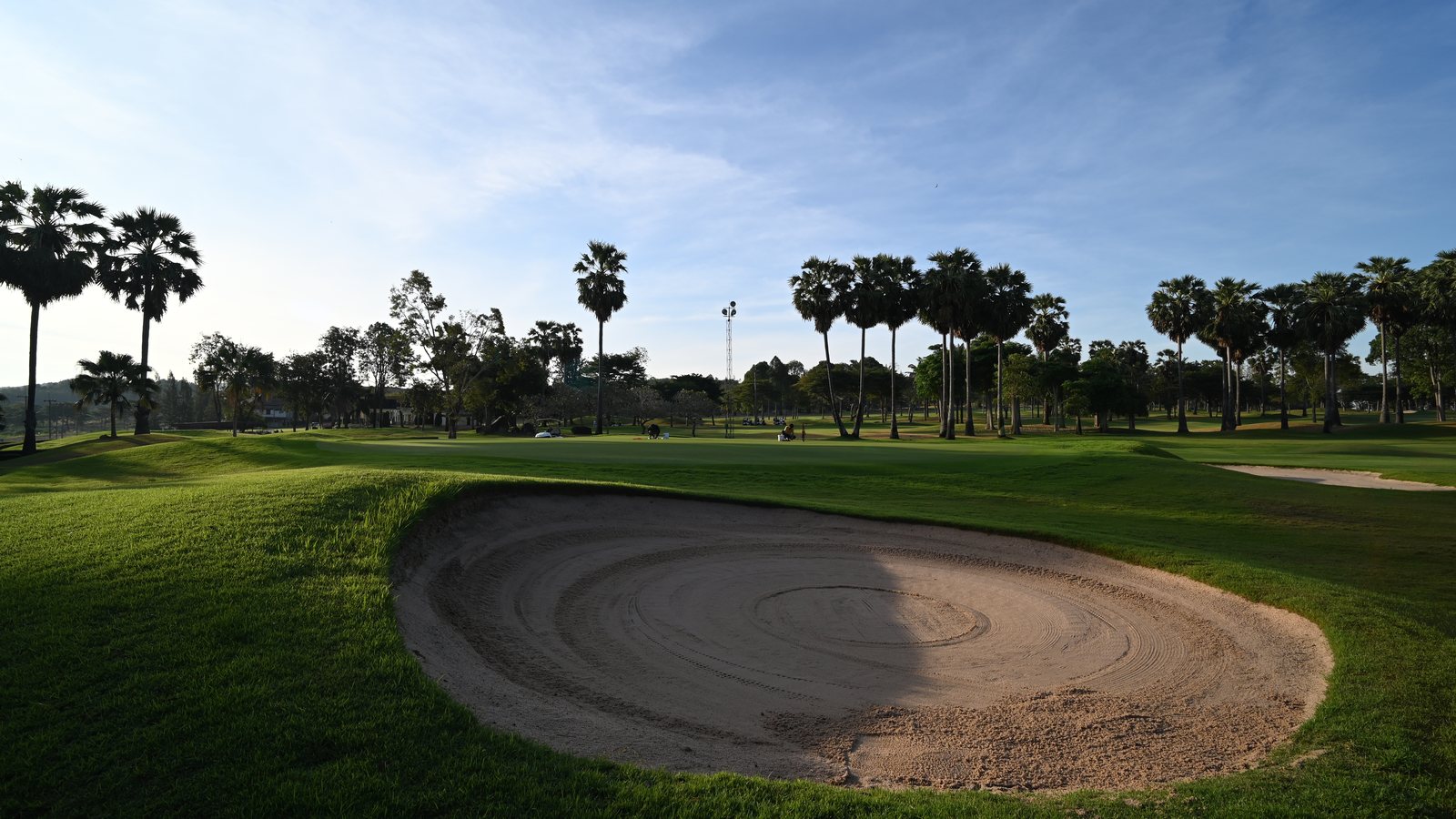 Golf course bunker raked in the sun